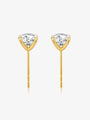 Detail view of round lab-grown diamond stud earrings in four-prong yellow gold settings