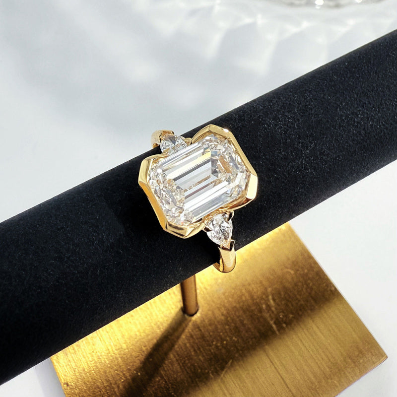 Close-up of the Emerald Heirloom Trio lab-grown diamond engagement ring with an emerald-cut center diamond and side stones