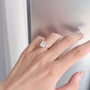 Model wearing the Emerald Heirloom Trio lab-grown diamond engagement ring with an emerald-cut center diamond