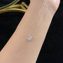 Close-up of the Geometric Solitaire round lab-grown diamond pendant necklace worn on the neckline