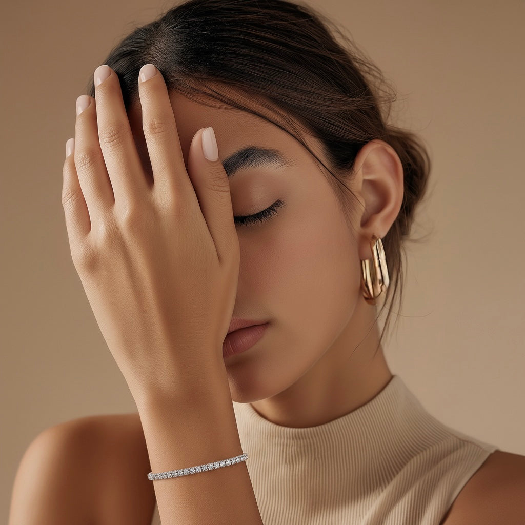 Model wearing a lab-grown diamond tennis bracelet with round brilliant diamonds, approximately 0.10ct each
