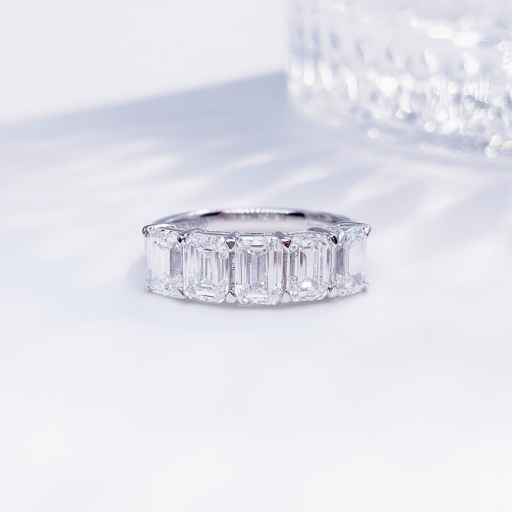 Front view of the Luminous Five emerald cut lab-grown diamond band ring with five diamonds in a clean row