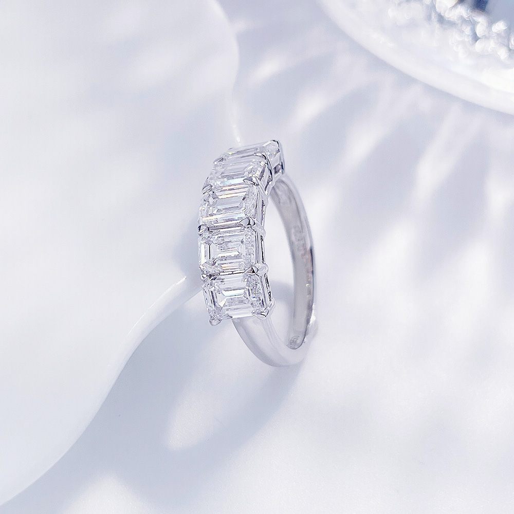 Side angle of an emerald cut lab-grown diamond band ring with five step-cut diamonds