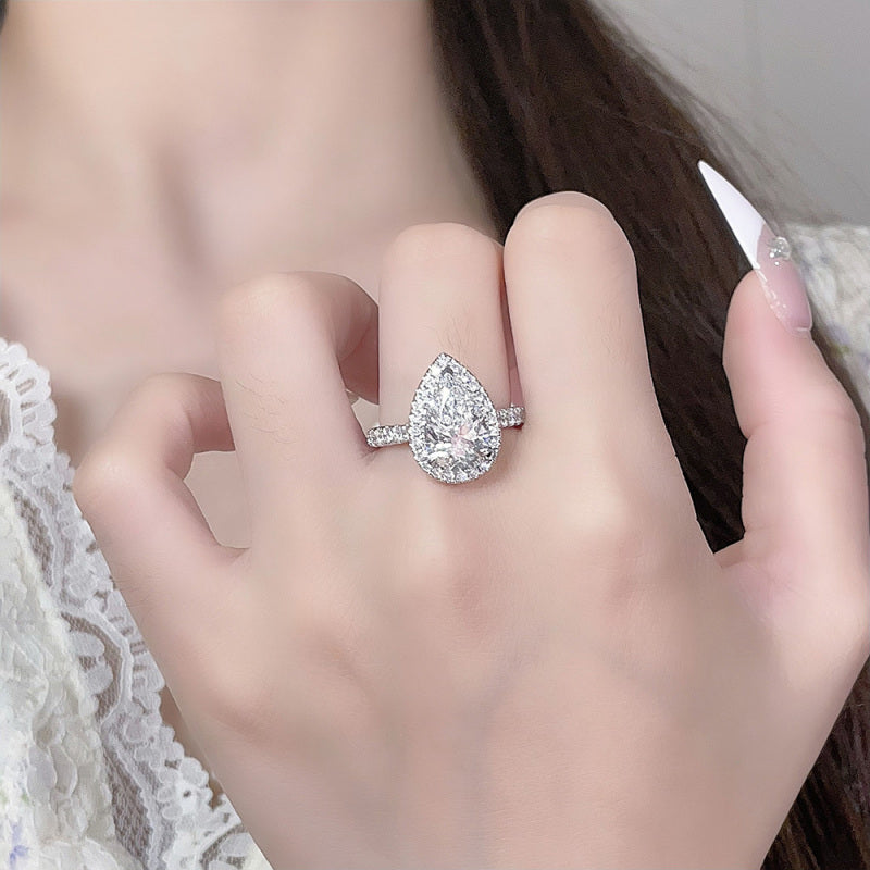 Model wearing the Pear Halo lab-grown diamond engagement ring with a pear-cut center diamond and pavé band