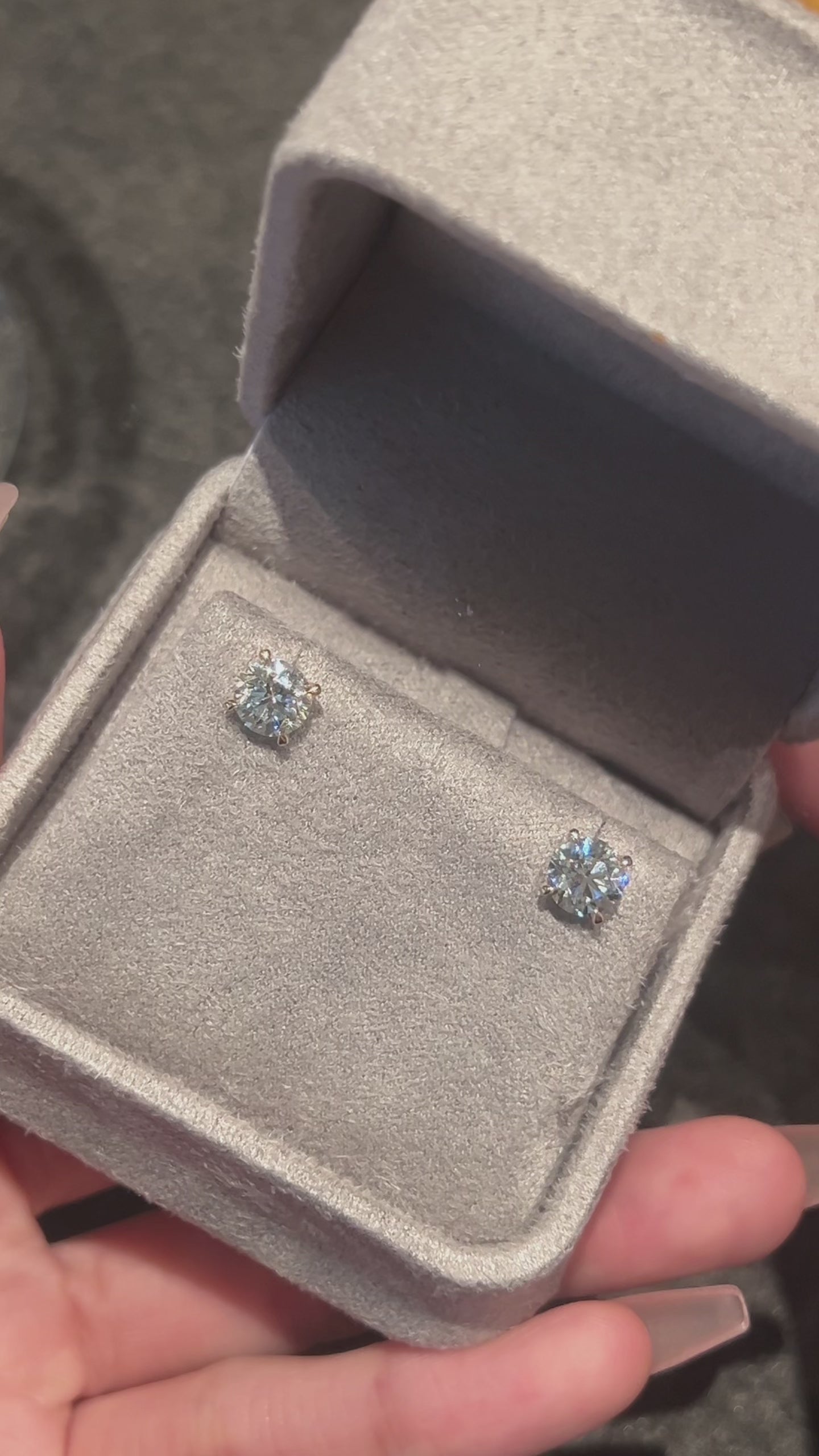 Video of the Classic Four-Prong round lab-grown diamond stud earrings featuring round brilliant diamonds in yellow gold settings