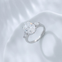 Angled view of the Soft Oval Trio lab-grown diamond engagement ring with an oval center diamond and delicate side stones