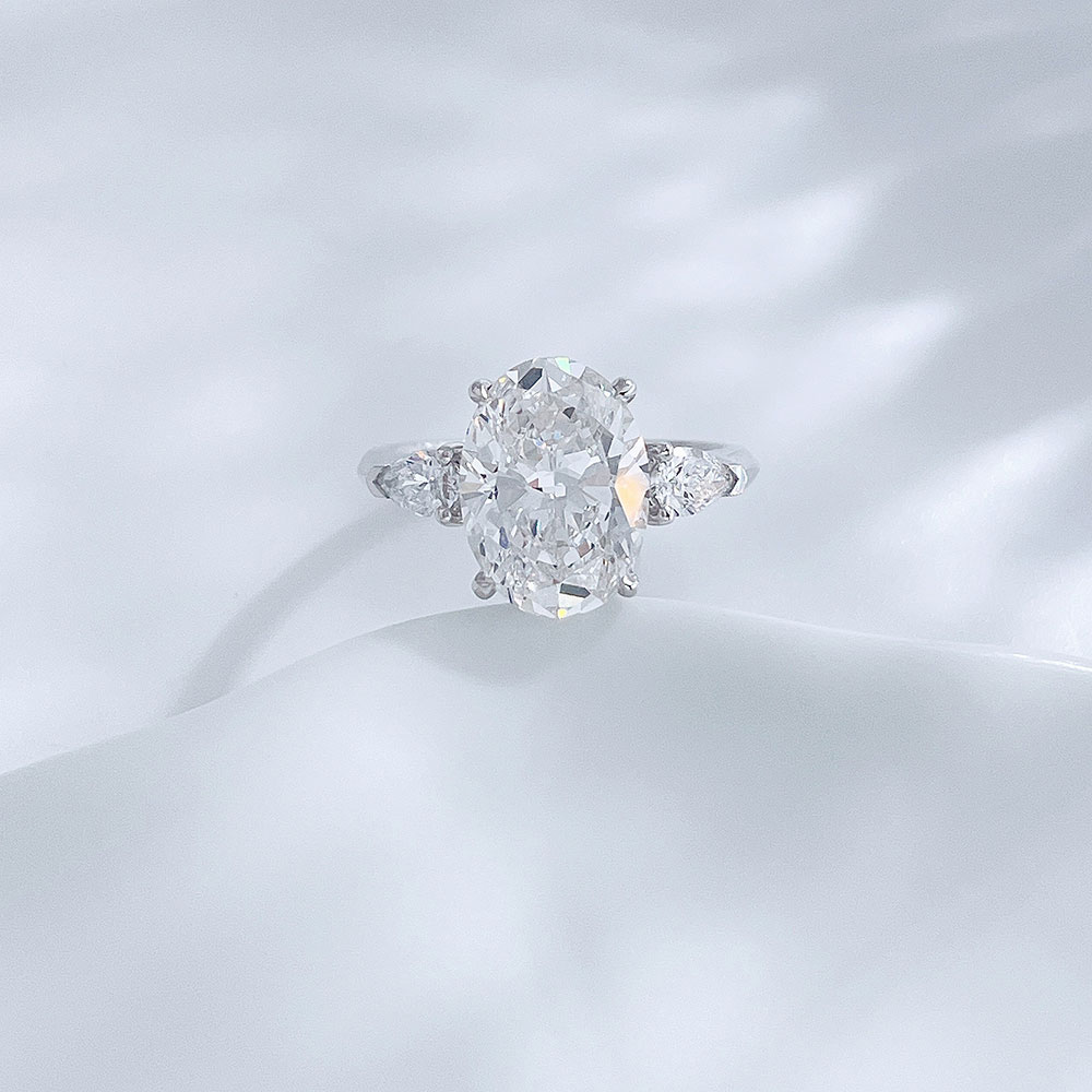Front view of the Soft Oval Trio lab-grown diamond engagement ring with an oval-cut center diamond and side stones
